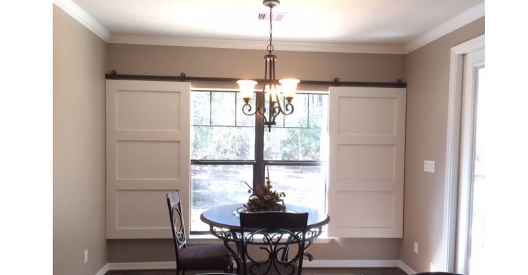 Barn doors open horizontally with slides instead of cords. New York barn door shutters