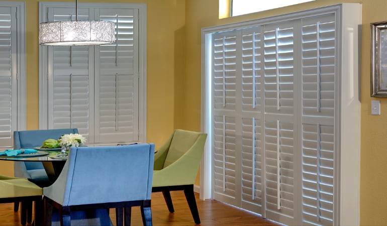 Plantation shutters on a French door function like common window shutters. Patio Doors with Plantation Shutters in New York