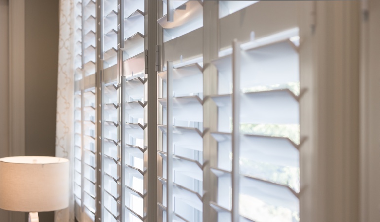East-West windows often have problems with glare during sunrises and sunsets. Plantation shutters close up