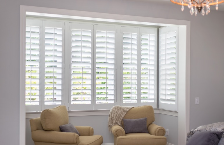 North-South windows may have energy efficiency problems rather than problems with sun glare. White plantation shutters in sitting area